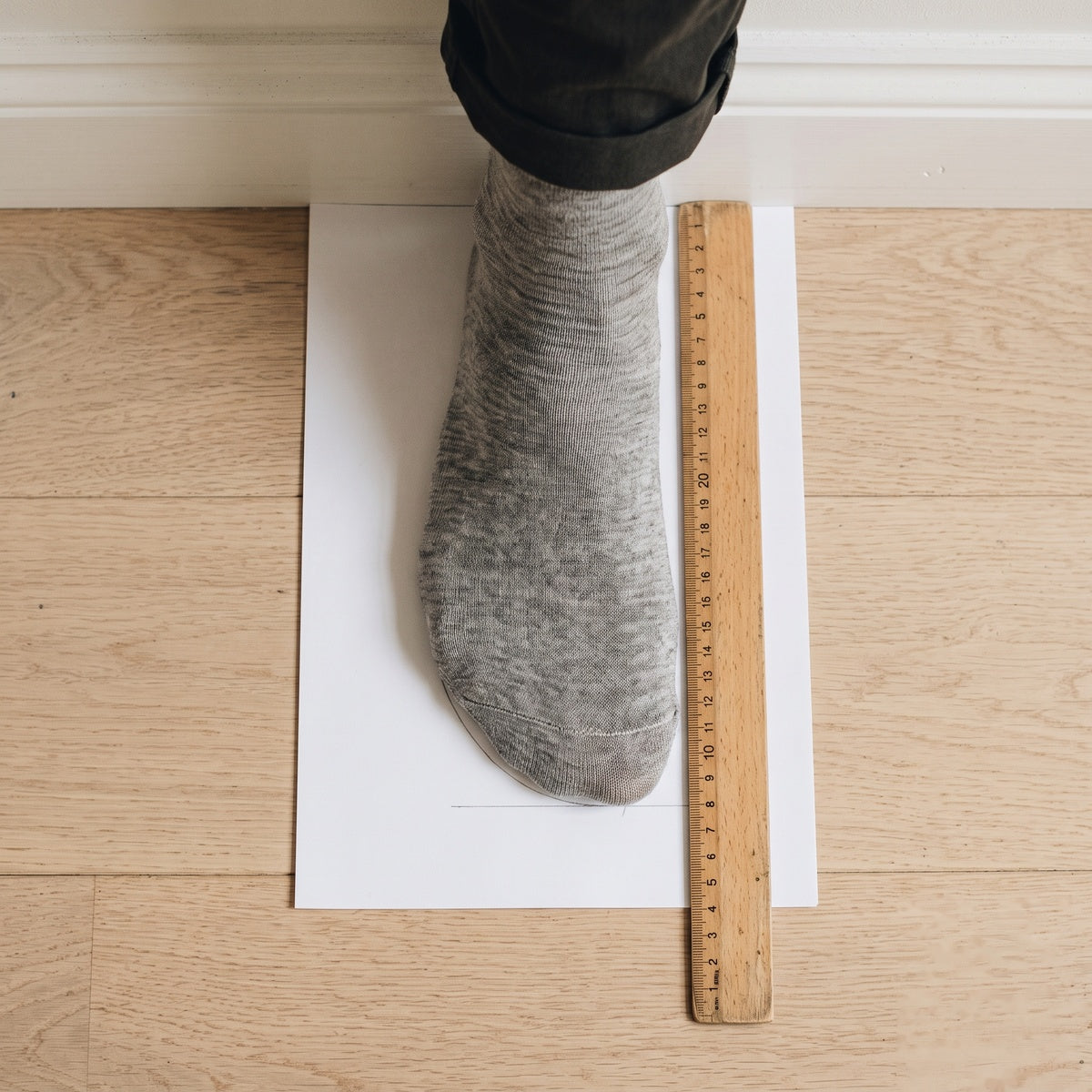 Measuring a foot against a wall